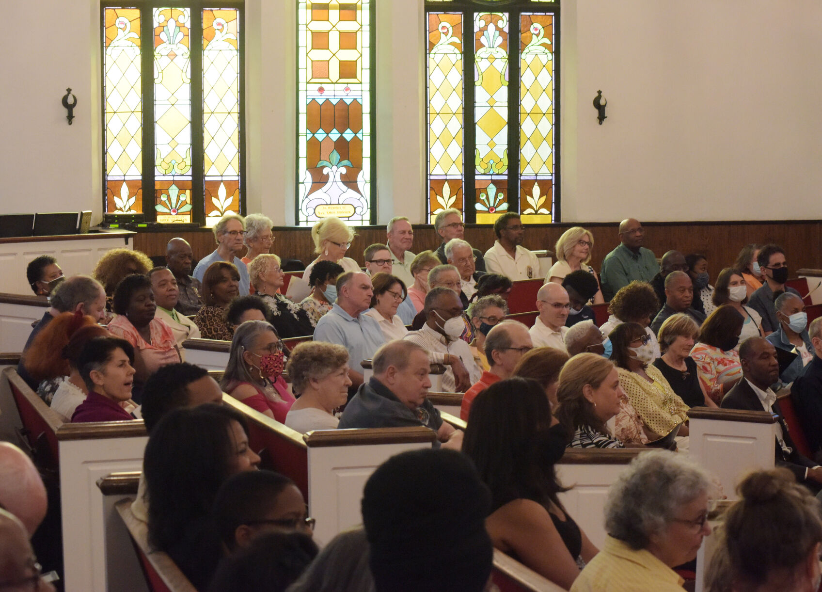 Members of the community gather to listen